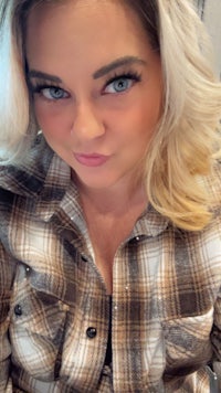 a woman in a plaid shirt posing for a photo